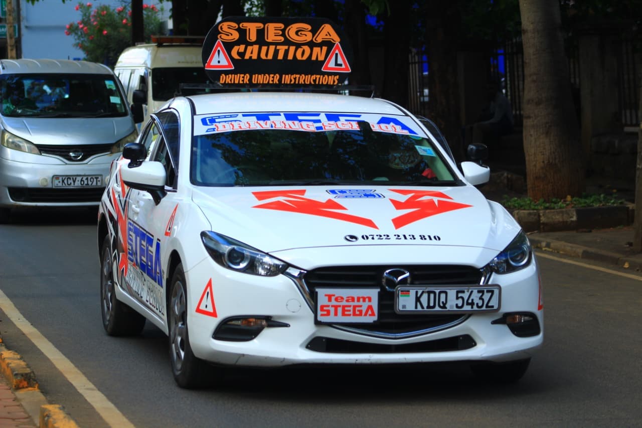 Team Stega — White Mazda3 on Nairobi roads